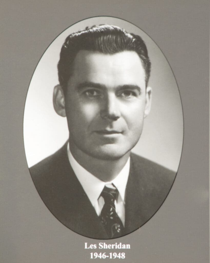 Black-and-white oval portrait of a man in a suit, with caption'Les Sheridan 1946–1948' below.