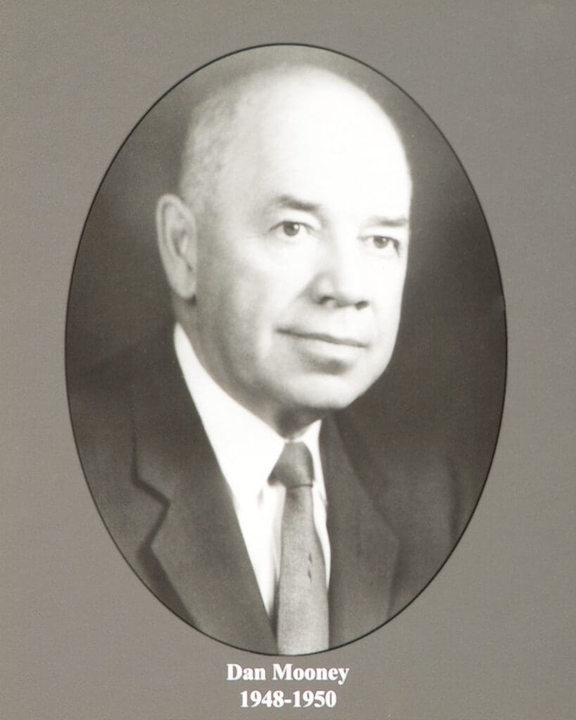 Portrait of Dan Mooney in a suit, inside an oval frame. Captions read “Dan Mooney 1948-1950.”