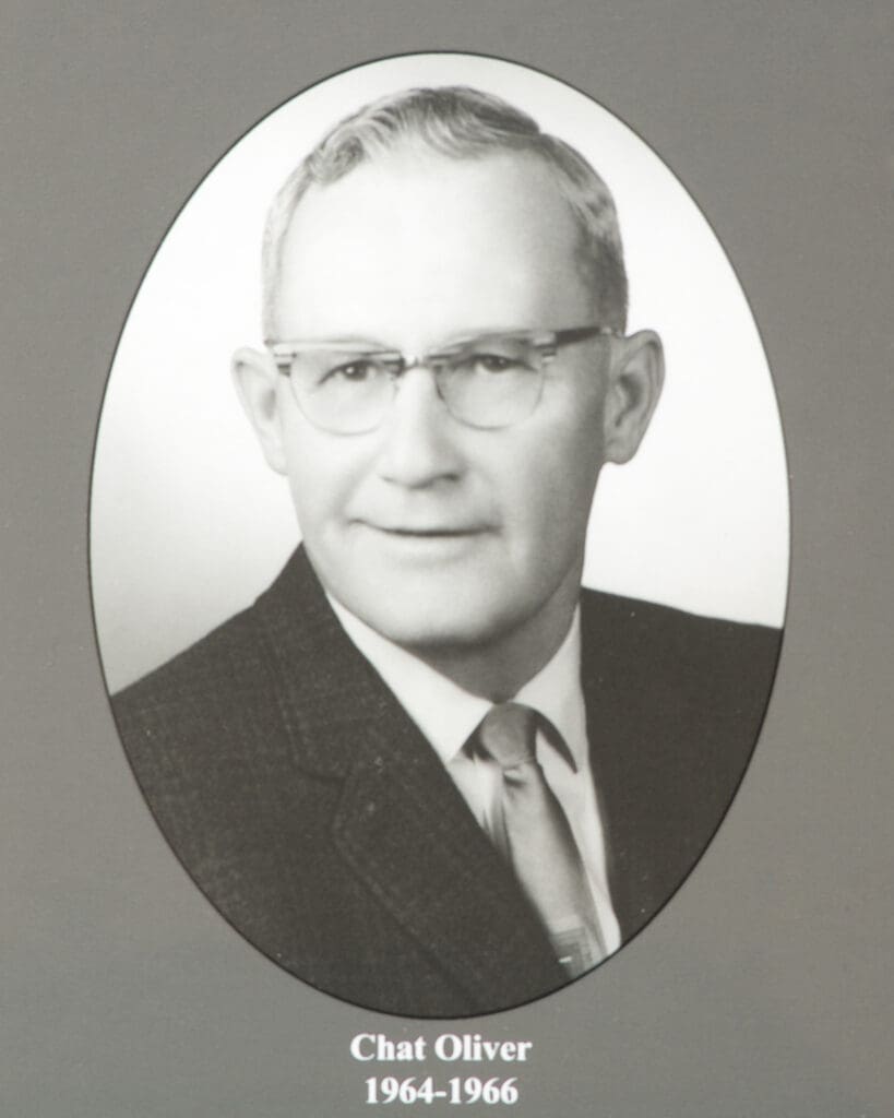 Black-and-white portrait of a man in a suit, shown in an oval frame with the caption'Chat Oliver 1964-1966' beneath.