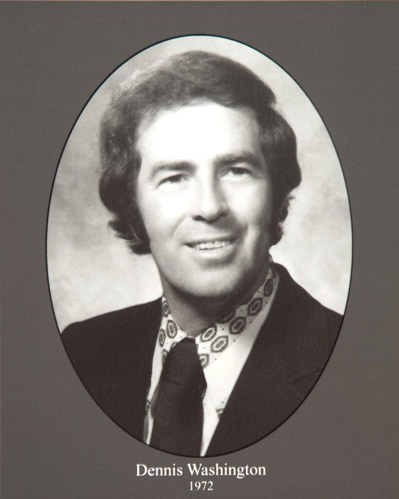 Oval black-and-white yearbook portrait of Dennis Washington, wearing a suit with a patterned tie, labeled'Dennis Washington 1972'