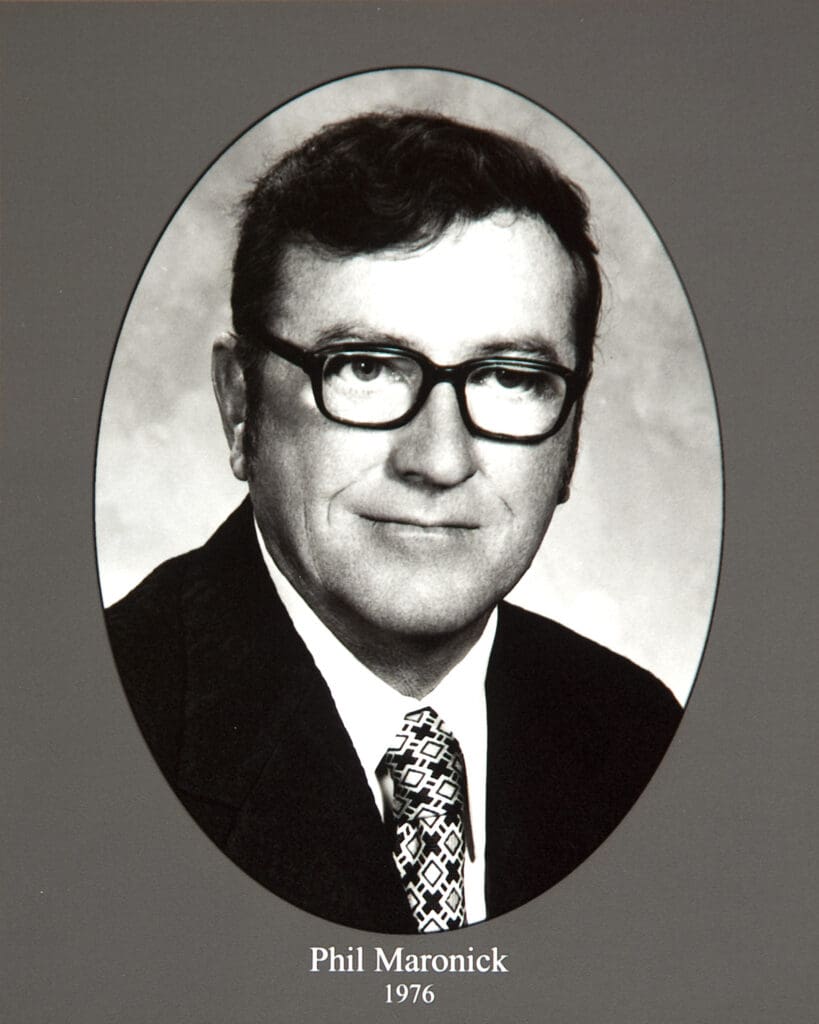 Black-and-white portrait of Phil Maronick in a suit and patterned tie, framed in an oval, 1976.