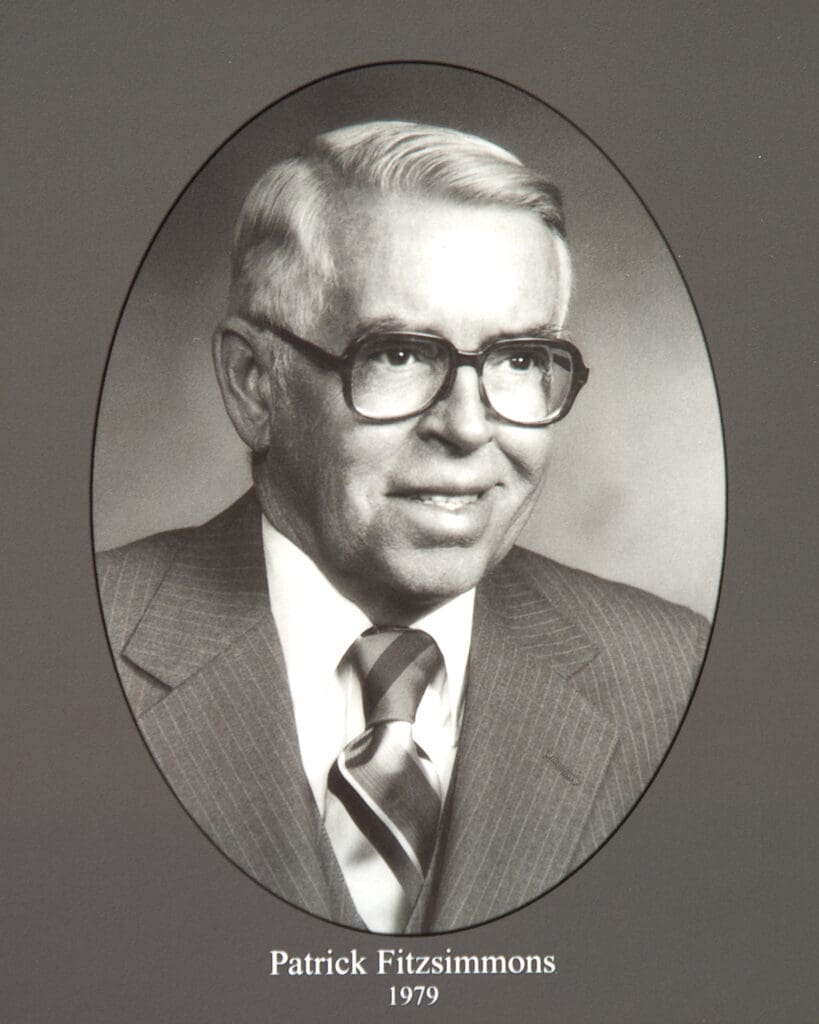 Oval studio portrait of Patrick Fitzsimmons wearing a suit and striped tie, year 1979 written below.