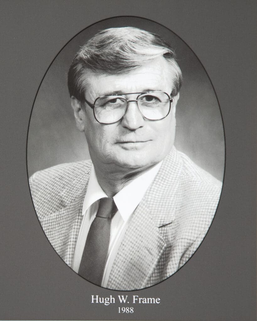 Black-and-white portrait of Hugh W. Frame in an oval frame, dated 1988, wearing a suit and tie.