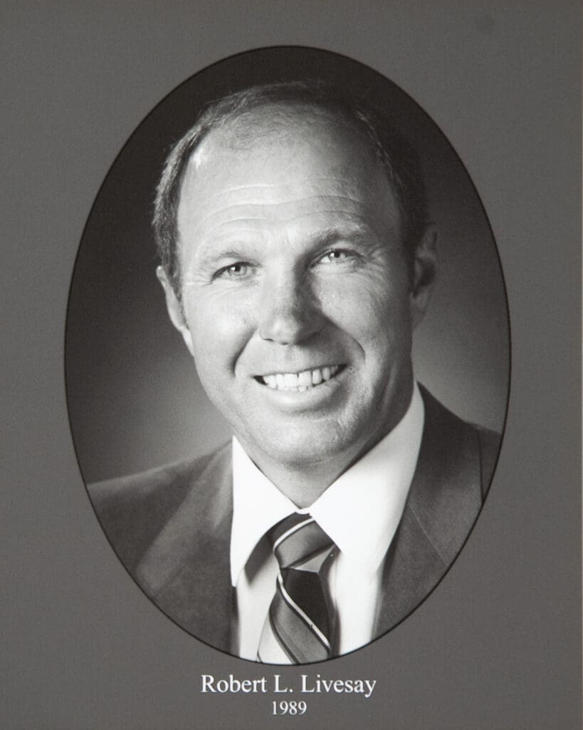 Portrait of a smiling man in a suit inside an oval frame; caption reads 'Robert L. Livesay, 1989'