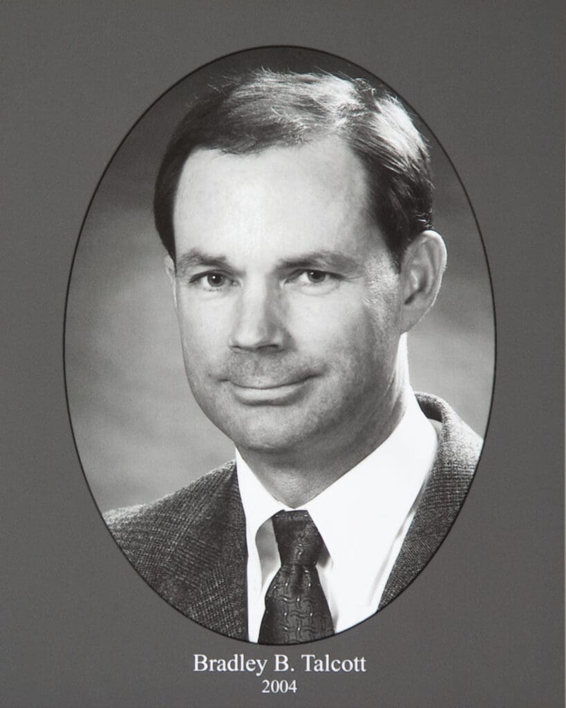Black-and-white portrait of Bradley B. Talcott in an oval frame, wearing a suit and tie; year 2004 displayed below.