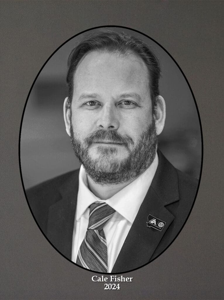 Black-and-white formal portrait of Cale Fisher in a suit and tie, shown in an oval frame.